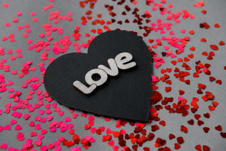 Black and red heart with the words love on Valentine's Day.