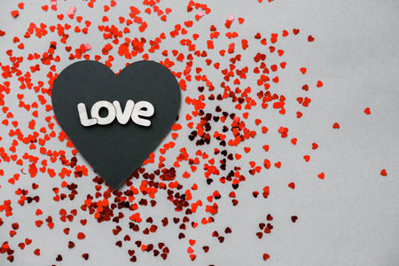 Black and red heart with the words love on Valentine's Day.