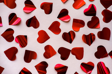 Red heart confetti on February 14 for Valentine's Day.