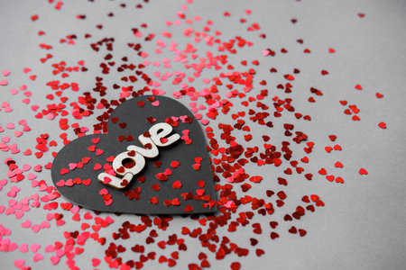Black and red heart with the words love on Valentine's Day.