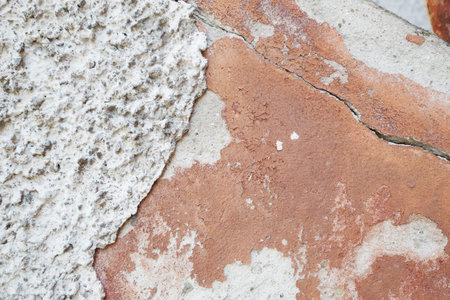 A crack in the concrete wall.Textured stone white wall. Peeling paint on the cement surface.の写真素材