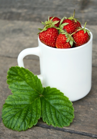 full white mug with red ripe strawberriesの写真素材