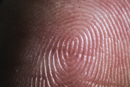 macro view of the fingers fingertips in the darknessの写真素材
