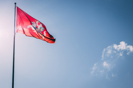 The coat of arms of Lithuania. Knight on a horse on a red background. Blue sky.の写真素材