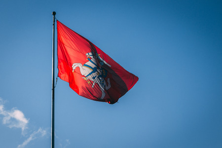 The coat of arms of Lithuania. Knight on a horse on a red background. Blue sky.の写真素材