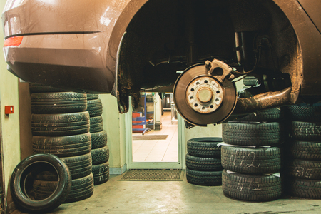 hanging car in a auto service workshopの写真素材