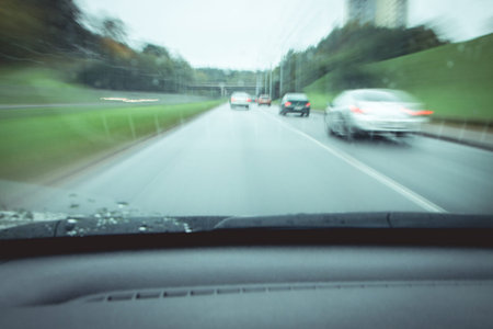 view from the car from the driver's seat. traffic of cars on the road. motion blur