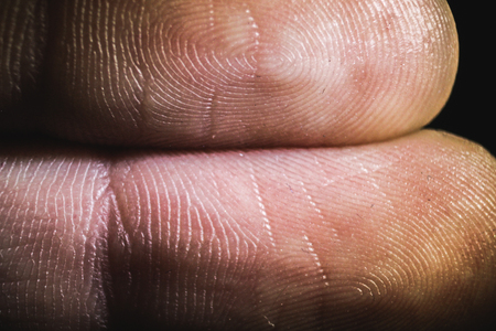 macro view of the finger's fingertips in the darknessの写真素材