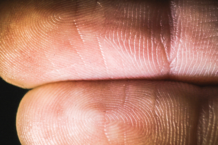macro view of the finger's fingertips in the darknessの写真素材