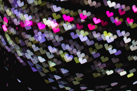 The bokeh of heart shape from the beautiful colourful light decoration at nightの写真素材