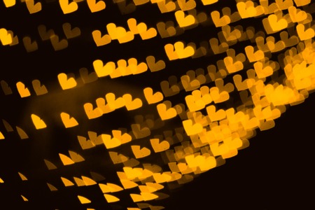 The bokeh of heart shape from the beautiful colourful light decoration at nightの写真素材