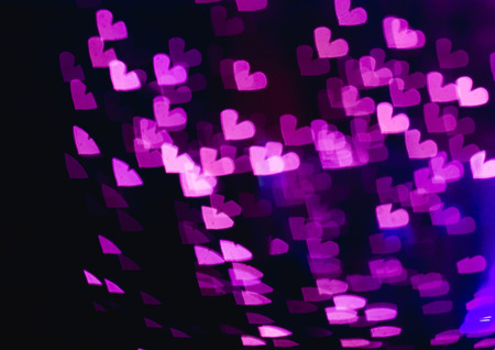 The bokeh of heart shape from the beautiful colourful light decoration at nightの写真素材