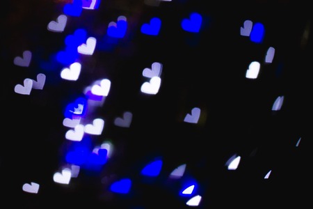 The bokeh of heart shape from the beautiful colourful light decoration at nightの写真素材