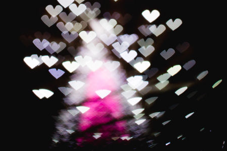 The bokeh of heart shape from the beautiful colourful light decoration at nightの写真素材