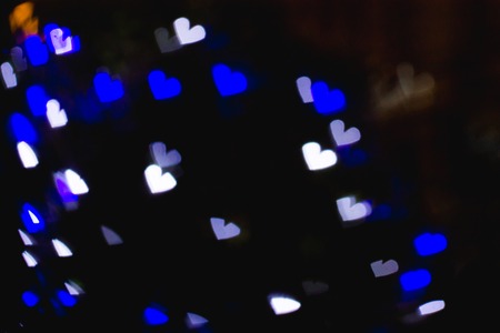 The bokeh of heart shape from the beautiful colourful light decoration at nightの写真素材