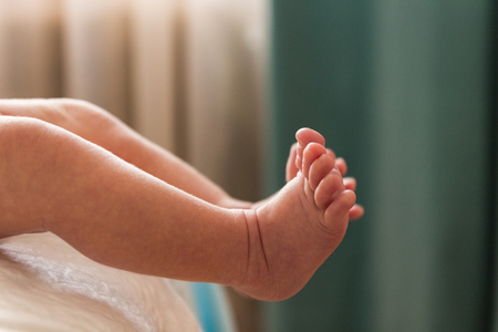 Two small legs of a baby. Blurred background.の写真素材