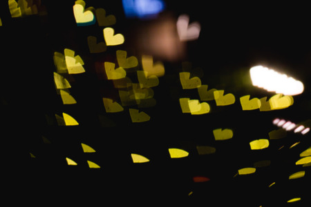 The bokeh of heart shape from the beautiful colourful light decoration at nightの写真素材