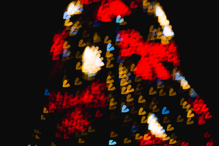 The bokeh of heart shape from the beautiful colourful light decoの写真素材