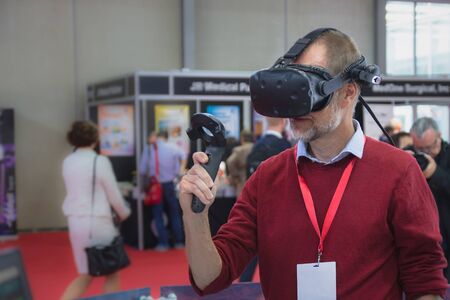 Vienna, Austria - September, 2018: man in red using VR equipmentのeditorial素材