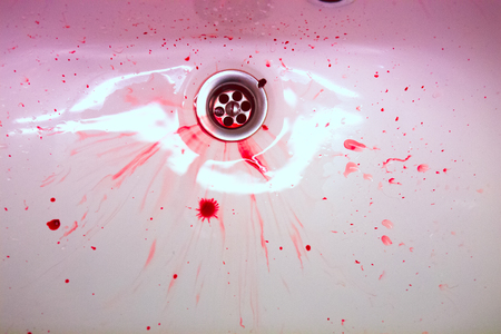 White ceramic sink with red blood stains. The concept of bloodyの写真素材