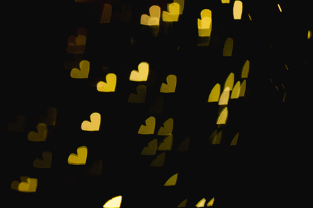The bokeh of heart shape from the beautiful colourful light decoration at nightの写真素材