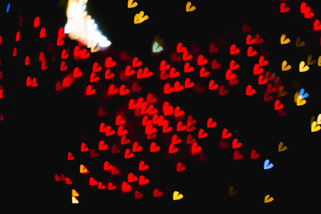 The bokeh of heart shape from the beautiful colourful light decoration at nightの写真素材