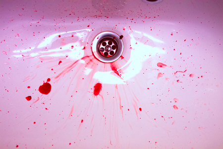 White ceramic sink with red blood stains. The concept of bloody suicide and diseaseの写真素材