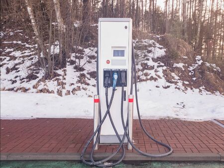 EV Electric car charging station. Snow on the backgroundの写真素材