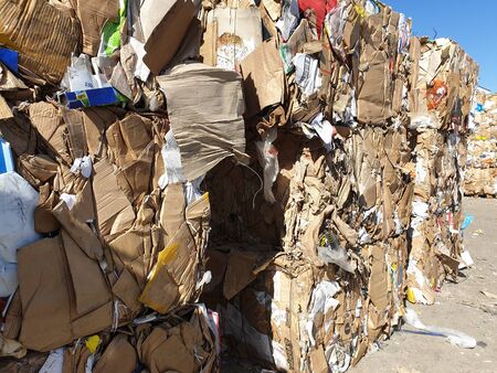 Stack of paper and cardboard garbage at recycling planの写真素材