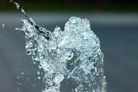 Water sculpture. Splashes frozen from the fountain in flight with water droplets with blurred...