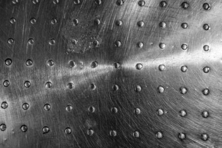 Texture of a metal surface dots silver colour.の写真素材