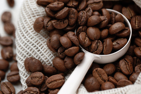 Rich brown coffee beans macro with  spoonの写真素材