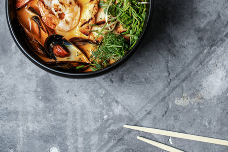 Asian noodle  ramen with pork, marinated egg, sprout on grey clay background