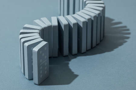 Light Blue wood domino pieces on light blue background. Leisure games concept.の写真素材