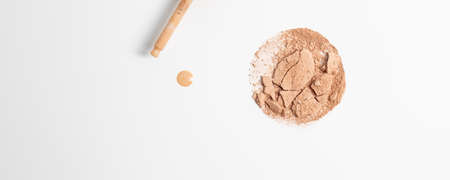 Crashed face finishing powder and serum liquid powder skin tint drop applied from dropper isolated on white backgroundの写真素材