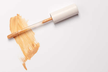 Skin serum foundation brush stroke with brush for applying isolated on white backgroundの写真素材