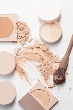 Set with Crashed beige face finishing, bronzing and liquid serum powder, zero waste wood finishing powder brush isolated on white backgroundの写真素材