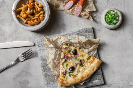 Tasty pizza with  sausage, mozzarella, marinated mushrooms, black olives, green onion on marble...