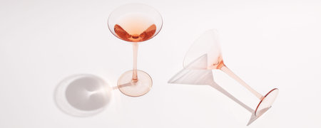 Rose wine in cocktail rose glasses on white background