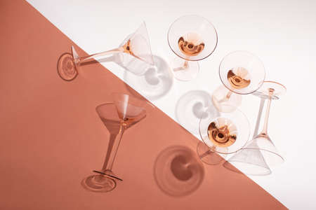 Rose wine in cocktail rose glasses on white and pink backgroundの写真素材