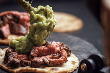 Process of cooking tacos with grilled flank beef steak with handmade guacamoleの写真素材