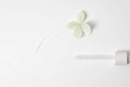 White cosmetic cream swipe isolated on white background with Hortensia flowers. Make up foundation smudge. BB, CC cream smear textureの写真素材