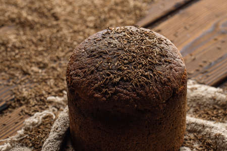 Round loaf of rye bread with thyme on rustic style wooden tableの写真素材