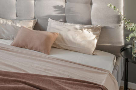 Linen pillow cushions in minimal bedroom interior. Beige, white and cream pillowsの写真素材