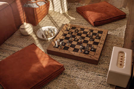 Ancient metal Roman Chess Set with silver and gold plated pieces on solid oak wood Board. Concept image for business strategy, competition, relaxation, recreation and mental agility.の写真素材