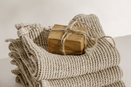 Organic handmade soap on waffle linen towels. Bathroom zero waste accessories. Daily body care, spa and wellness zero waste bathroom conceptの写真素材