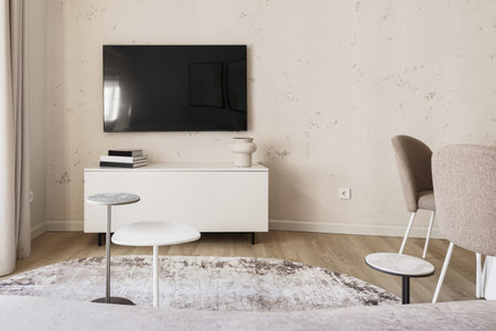Modern living room interior in pastel colours with creamy white furniture. Trendy minimalistic...
