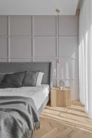 Modern minimalist bedroom interior design with grey furniture, oak floor in Scandinavian style.  Aesthetic simple interior design concept.の写真素材