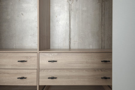 Empty contemporary wooden wardrobe design with concrete wallの写真素材