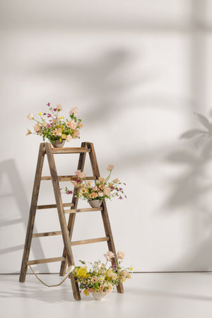 Fresh cut flower arrangement on wooden ladder in a vase for decoration for home, for interiors.Flowers delivery concept. Spring conceptの写真素材